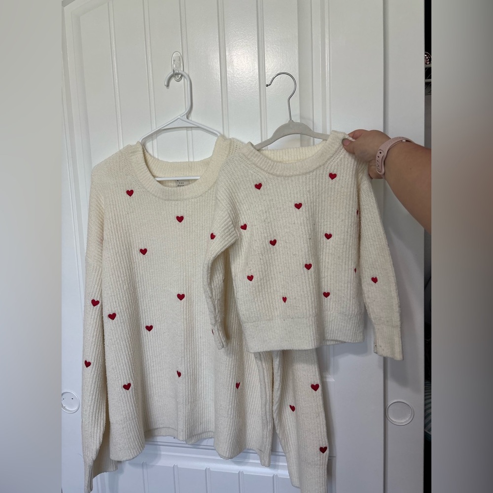Matching Cream Sweaters with Red Hearts